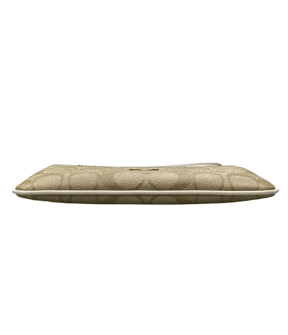 coach beige pouch / clutch side view